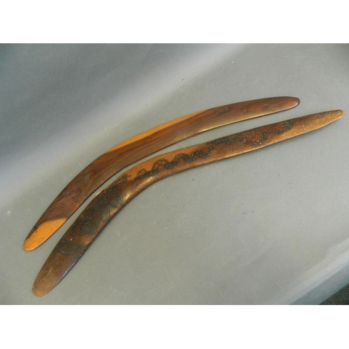 50U - A hardwood boomerang with engraved decoration of snakes and bush, and another, 27