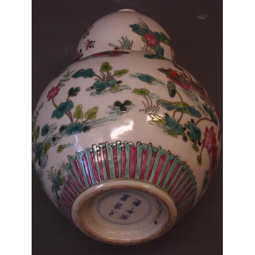 52 - A Chinese gourd shaped porcelain vase with lotus and bird decoration in bright enamels, 6 character ... 