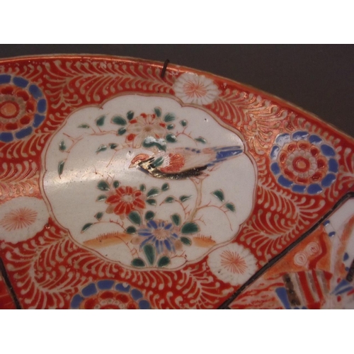 61 - A Japanese Meiji period dish with bright red enamel decoration and paintings of samurai, 6 character... 