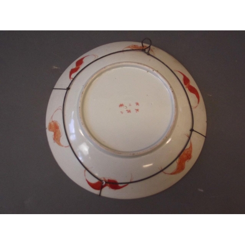 61 - A Japanese Meiji period dish with bright red enamel decoration and paintings of samurai, 6 character... 