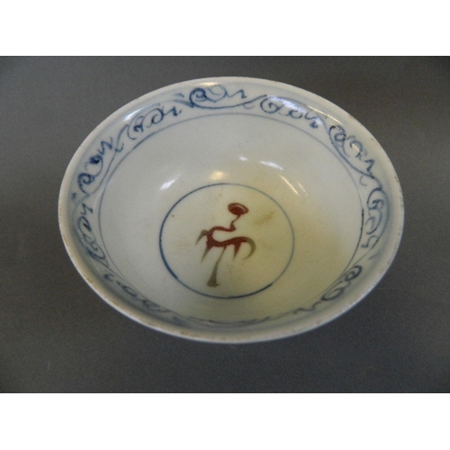 65 - A Chinese porcelain stem bowl decorated in blue and red with a dragon amongst clouds, 3½