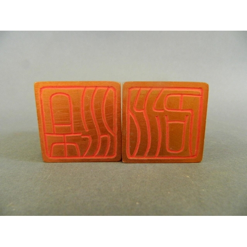 77 - A pair of Chinese square section amber soapstone seals decorated with calligraphy, 1½