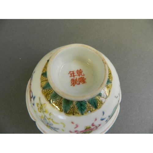 79 - A pair of Chinese polychrome porcelain tea bowls with a petal shaped rim and enamel decoration of th... 