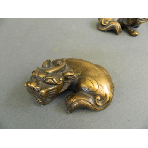 8 - A pair of Chinese bronze scroll weights in the form of kylin, 4