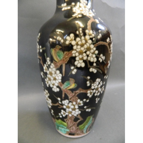 20 - A Chinese famille noire glazed porcelain vase of baluster form decorated with birds roosting in a fl... 