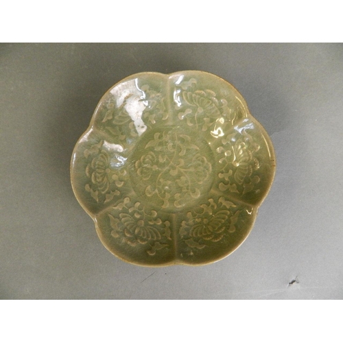 28 - A Chinese Song style petal shaped dish with a green glaze and incised floral decoration, 6