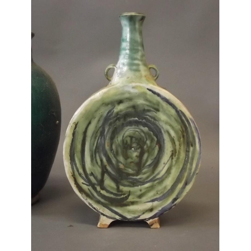 30 - A studio pottery flask, signed to base, and a green glazed vase with brass mounts, 15