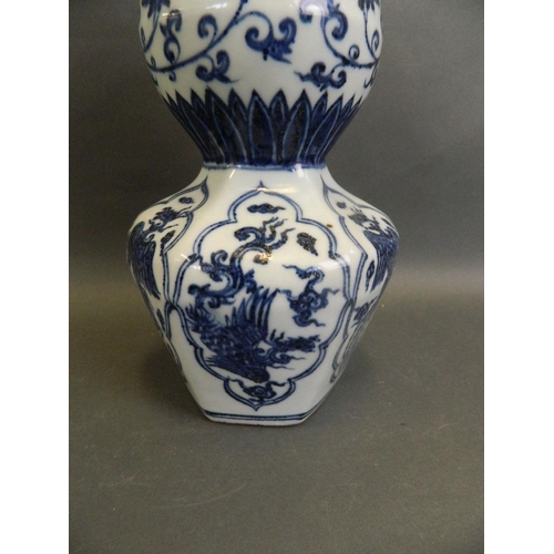 43 - A Chinese blue and white porcelain double gourd vase with octagonal shaped base and decorative panel... 