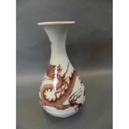 45 - A Chinese pear shaped stoneware vase decorated with a fiery dragon in ironstone red, 8½