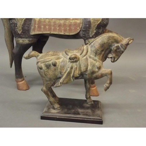 47 - An Eastern carved wood figure of a horse with brass and copper saddle and mounts, together with an O... 