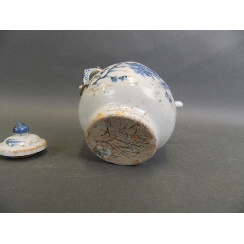 48 - A Chinese Ming style blue and white porcelain teapot with a dragon handle and prunus blossom decorat... 