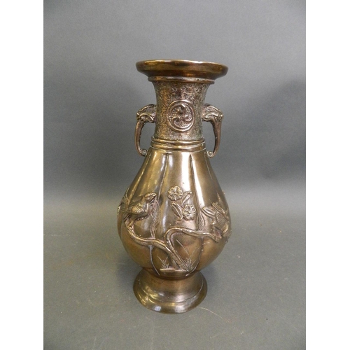 50M - An Oriental bronze ribbed vase with twin elephant mask handles and applied relief decoration of bird... 