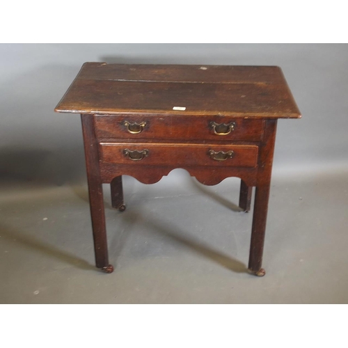 780 - A Georgian oak two drawer lowboy, raised on square chamfered supports, 31