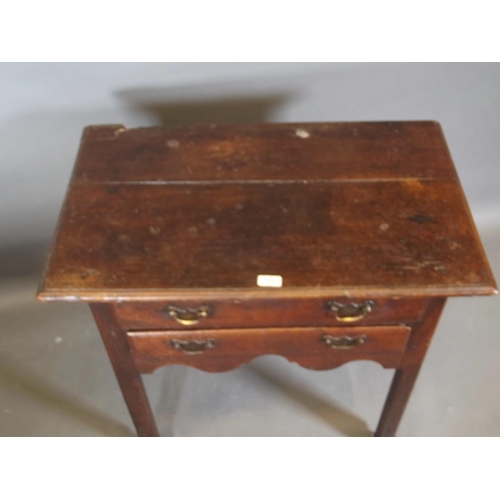 780 - A Georgian oak two drawer lowboy, raised on square chamfered supports, 31