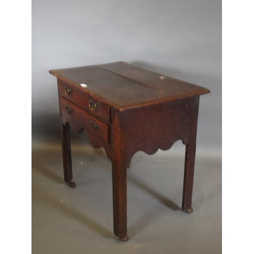 780 - A Georgian oak two drawer lowboy, raised on square chamfered supports, 31