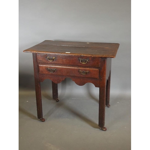 780 - A Georgian oak two drawer lowboy, raised on square chamfered supports, 31