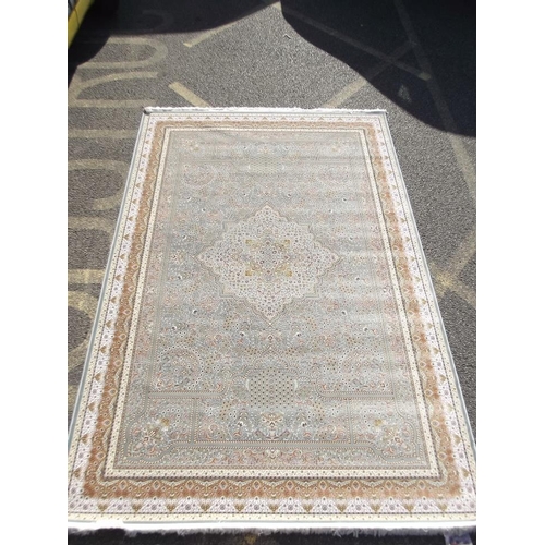 784 - A jade ground woven silk carpet with unique all over design, 79