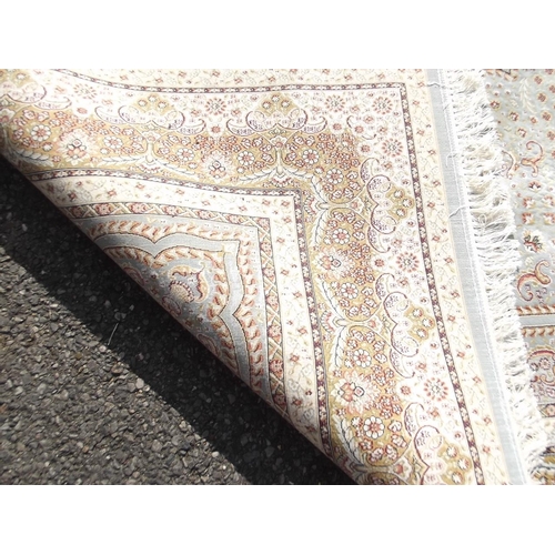 784 - A jade ground woven silk carpet with unique all over design, 79