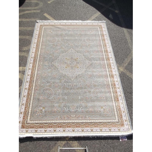 784 - A jade ground woven silk carpet with unique all over design, 79