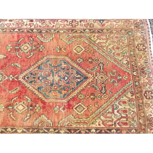 783 - An old red ground Persian Sarouk runner, signed and dated, 42