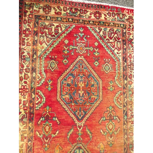 783 - An old red ground Persian Sarouk runner, signed and dated, 42