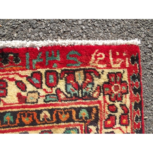 783 - An old red ground Persian Sarouk runner, signed and dated, 42