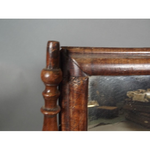 814 - An C18th walnut swing toilet mirror with cushion moulded frame, 19