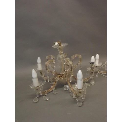 787 - A five branch glass chandelier, a three branch glass chandelier, a three tier brass and crystal drop... 