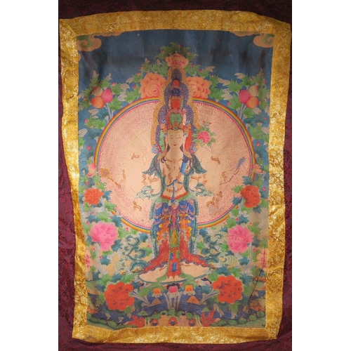 16 - A Tibetan printed silk thangka depicting Buddha surrounded by lotus flowers and peaches, 31