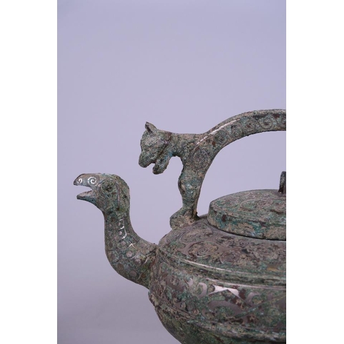 30 - A Chinese Song style mixed metal ewer with phoenix head spout and green patina, raised on tripod sup... 