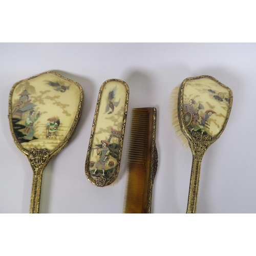 36 - A chinoiserie four piece dressing table set comprising hand mirror, two brushes and a comb, with gil... 