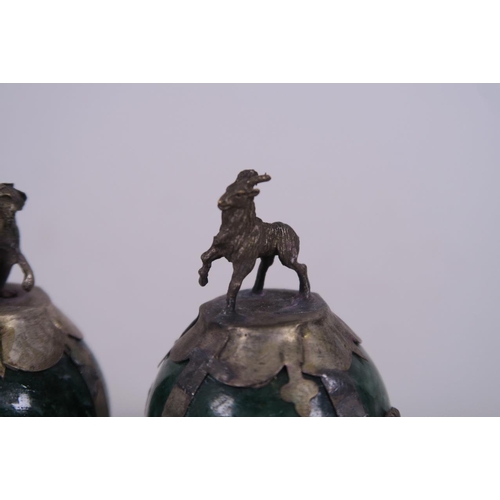 50H - A pair of Chinese white metal mounted green hardstone paperweights with goat and monkey finials, 2