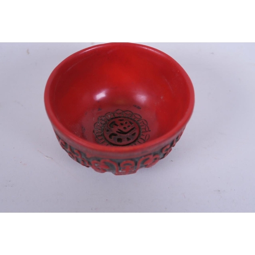 50J - A Chinese cinnabar lacquer style cup decorated with symbols and bats, 3