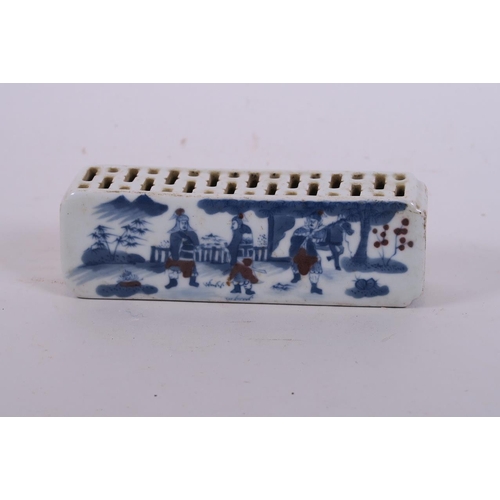 50K - A Chinese blue and white porcelain wrist rest with pierced sides and painted decoration of warriors,... 