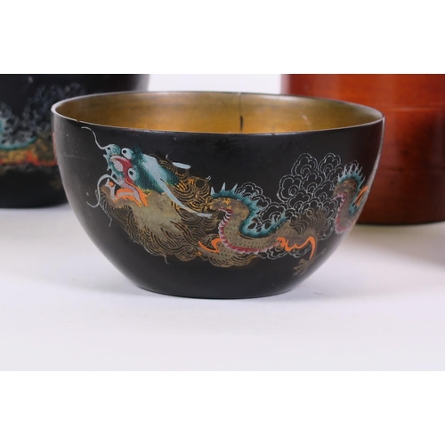 8 - A pair of Chinese black lacquer rice bowls decorated with dragons in bright enamels, together with a... 