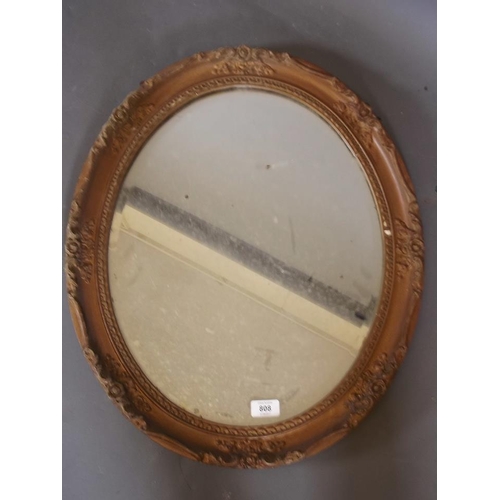 811 - A Victorian gilt oval wall mirror with bevelled glass, 23