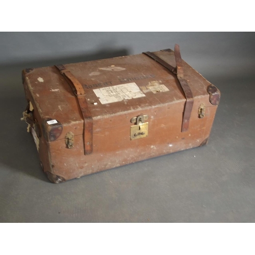 812 - A vintage steamer trunk with leather reinforced corners and strapping, bears label 'Guaranteed Flaxi... 