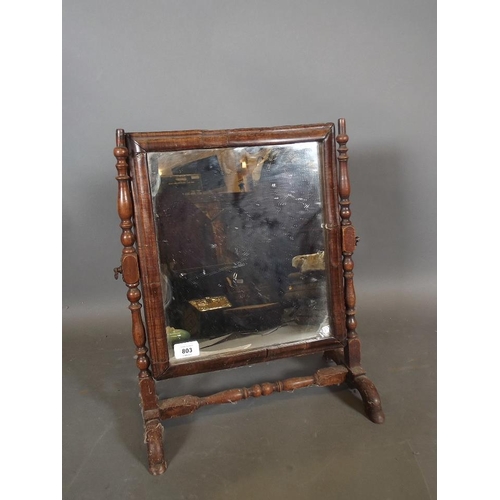 814 - An C18th walnut swing toilet mirror with cushion moulded frame, 19