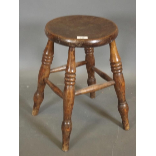 820 - A C19th elm stool raised on turned supports, 12