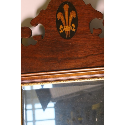 931 - A Regency style mahogany framed wall mirror, the fretted crown inlaid with a fleur-de-lis, 38