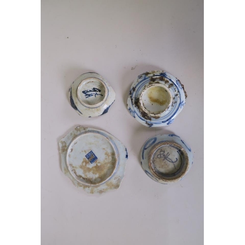 22 - A collection of four late C18th/early C19th Chinese blue and white pottery base shards, largest 5½