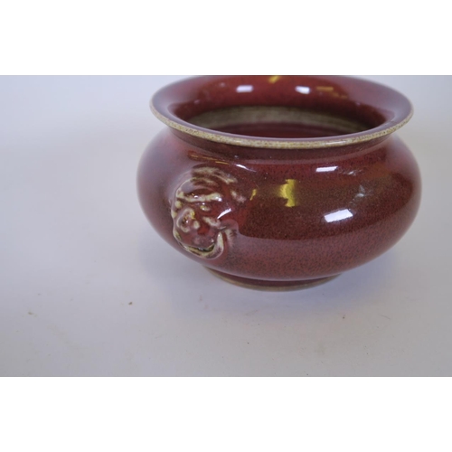 29 - A Chinese flambé glazed pottery censer with twin mask handles, 5