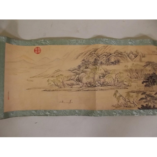 3 - A Chinese printed scroll depicting an extensive landscape with figures, temples and calligraphy, 10½... 