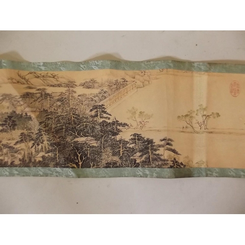 3 - A Chinese printed scroll depicting an extensive landscape with figures, temples and calligraphy, 10½... 