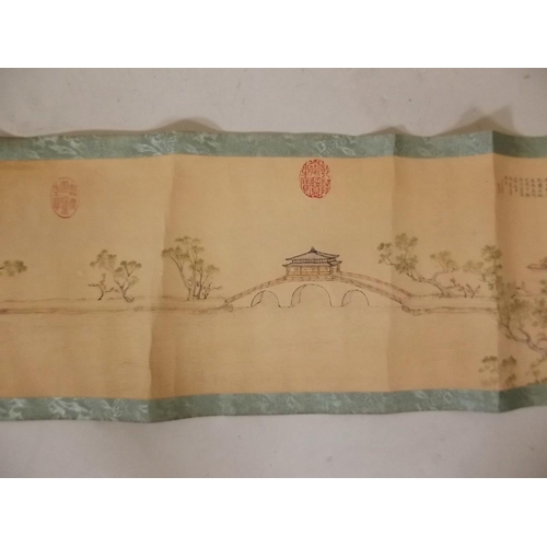 3 - A Chinese printed scroll depicting an extensive landscape with figures, temples and calligraphy, 10½... 