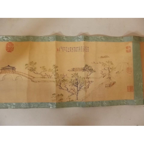 3 - A Chinese printed scroll depicting an extensive landscape with figures, temples and calligraphy, 10½... 