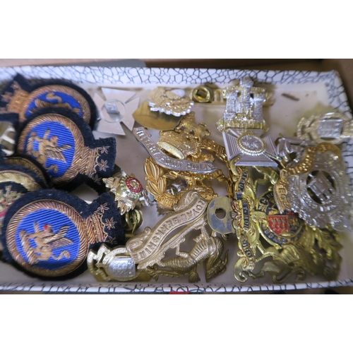 36 - A collection of military and other cap badges, and a quantity of fabric badges, stripes etc