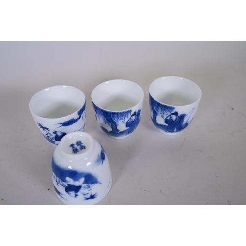 50E - A set of four Chinese blue and white porcelain tea bowls decorated with a sage and boys, 4 character... 