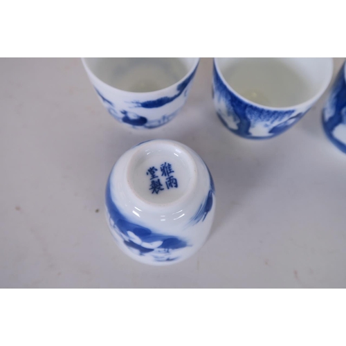 50E - A set of four Chinese blue and white porcelain tea bowls decorated with a sage and boys, 4 character... 