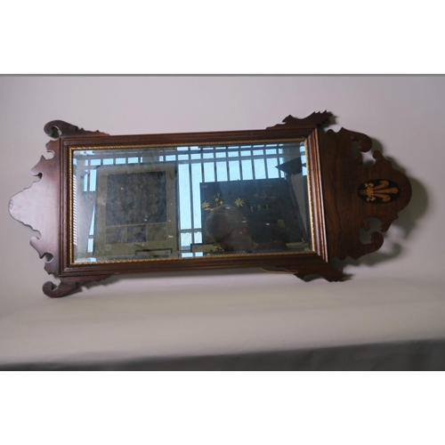 931 - A Regency style mahogany framed wall mirror, the fretted crown inlaid with a fleur-de-lis, 38